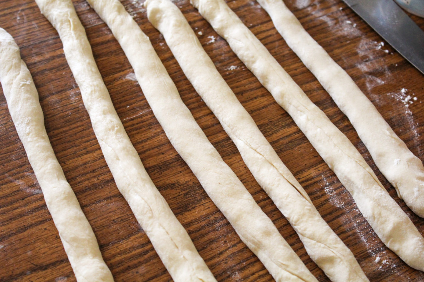 roll the dough into logs so you can start making soft pretzels 