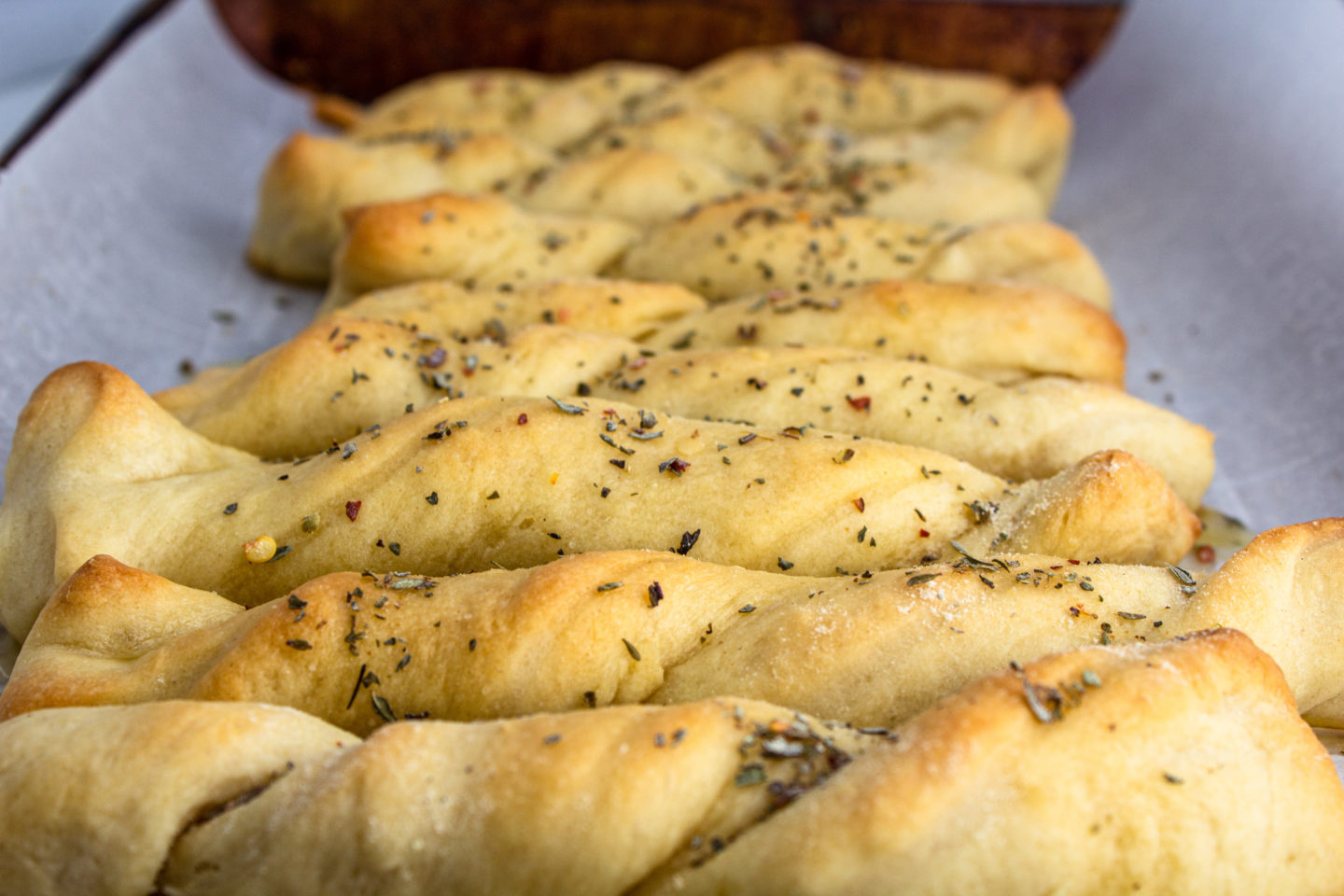 a picture of delicious buttery garlic twisted breadsticks (vegan)